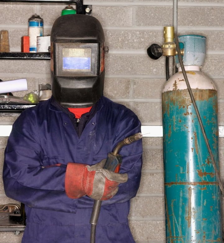 a welder posing in safety gear