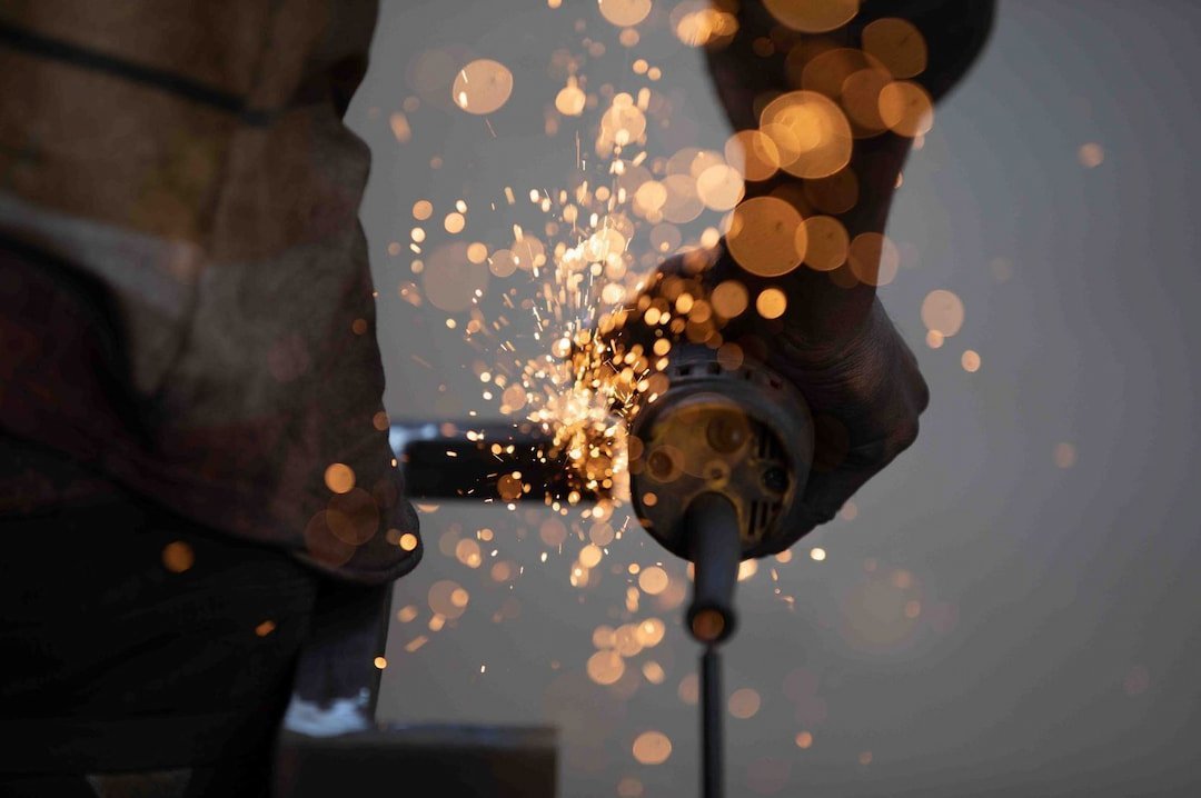 a welder's hand holding the tools