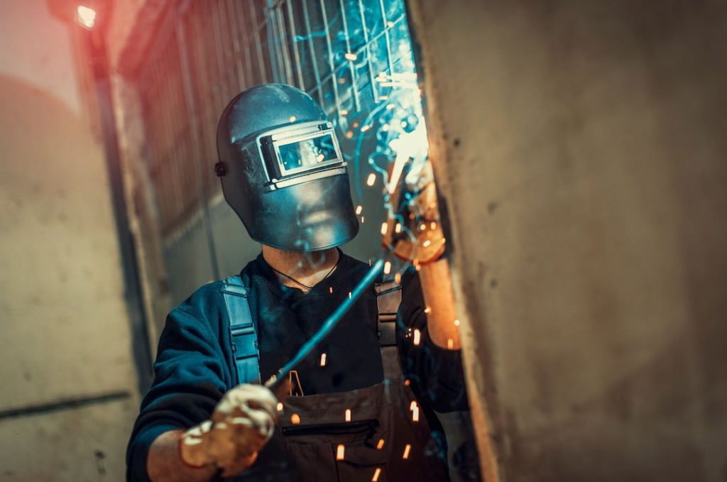 A man with helmet welding