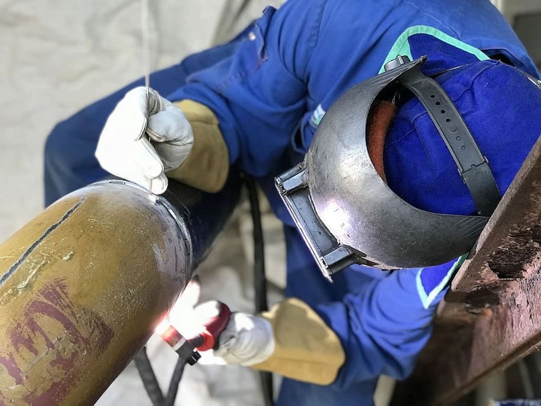 Closeup of a welder working on the pipe