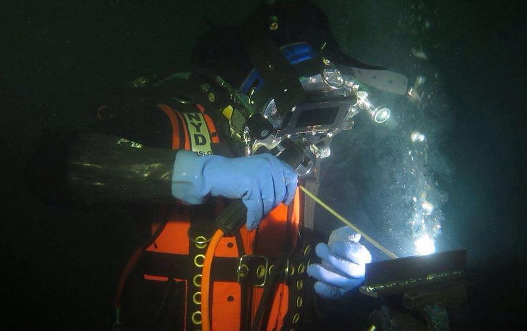 A person welding under the water
