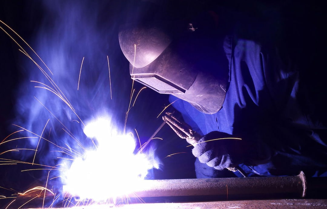 A welder with a helmet working