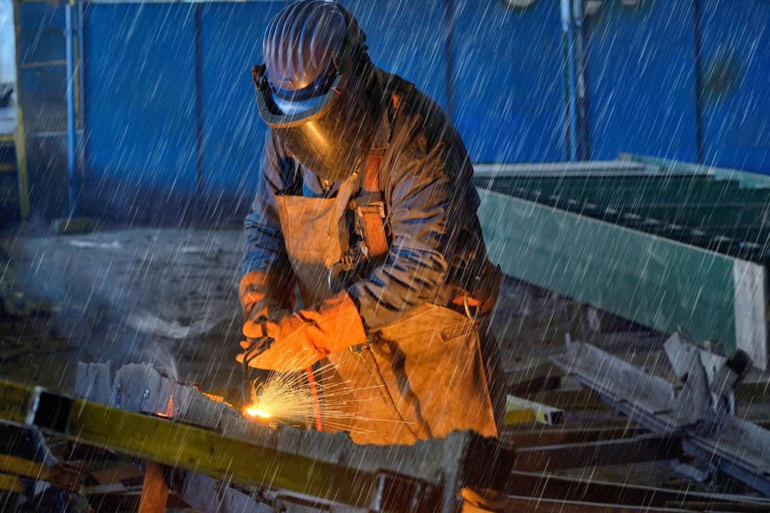 A welder working in the rain