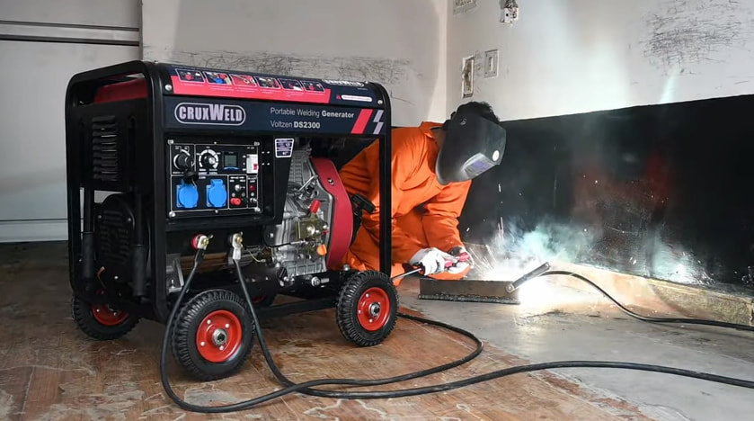 A person welding with generator